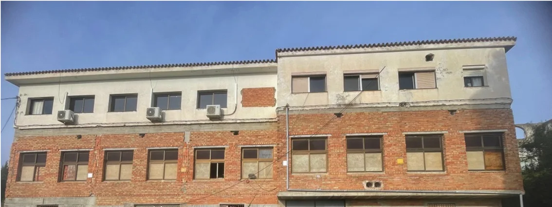 Three-storey brick building seen from the grounds