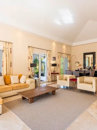 Living room with a vaulted ceiling and garden doors