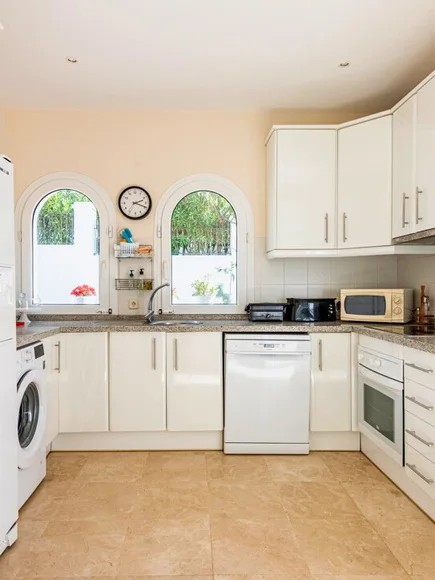 Fitted kitchen with arched windows