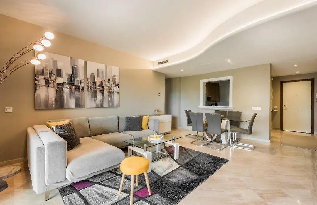 Living room with corner sofa and curved, lit ceiling