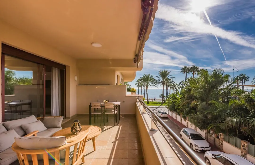 Covered terrace with outdoor sofa and dining table