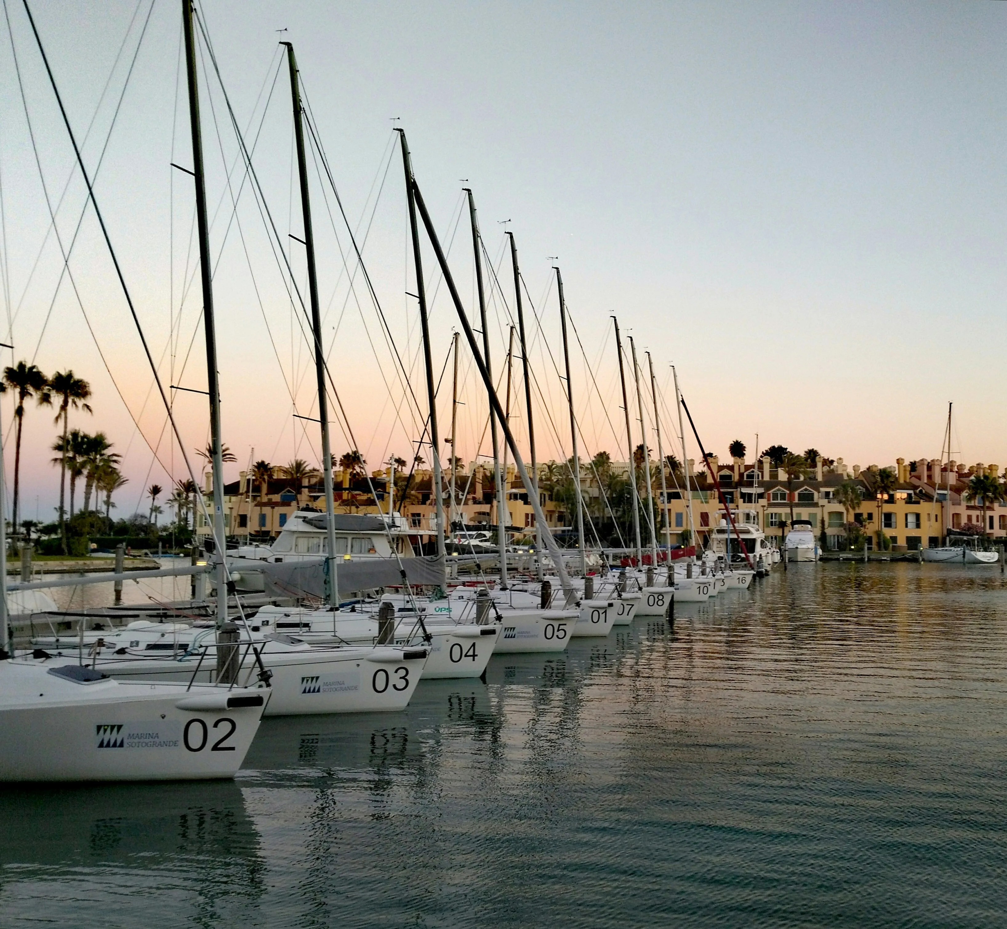 Sailing boats moored at the Sotogrande marina at dusk